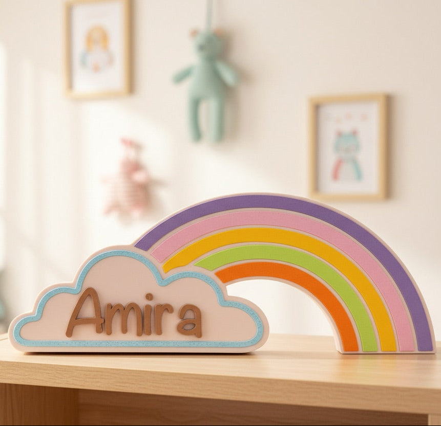 Rainbow and cloud decoration with 'Amira' on a shelf in a child's room.